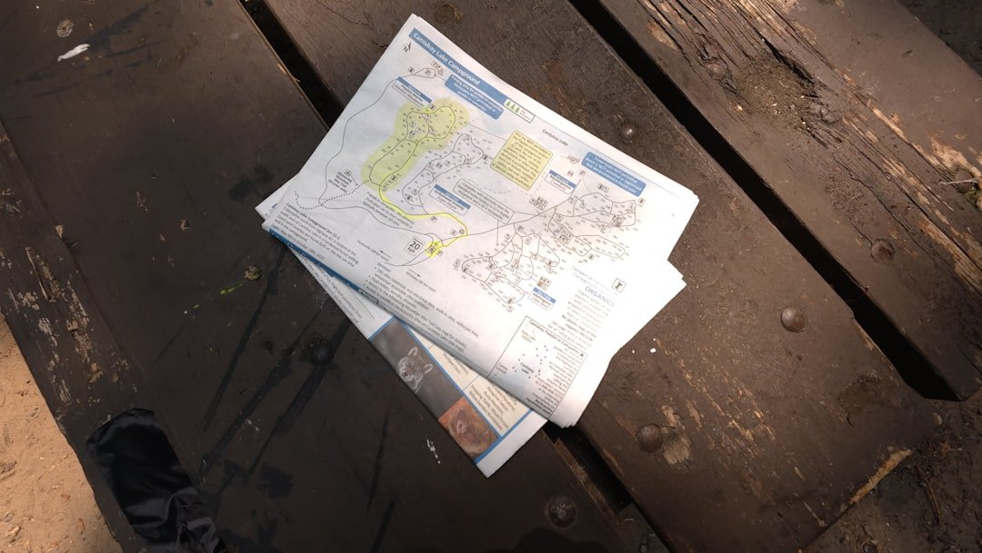 Folded newspaper lying on a wooden surface.